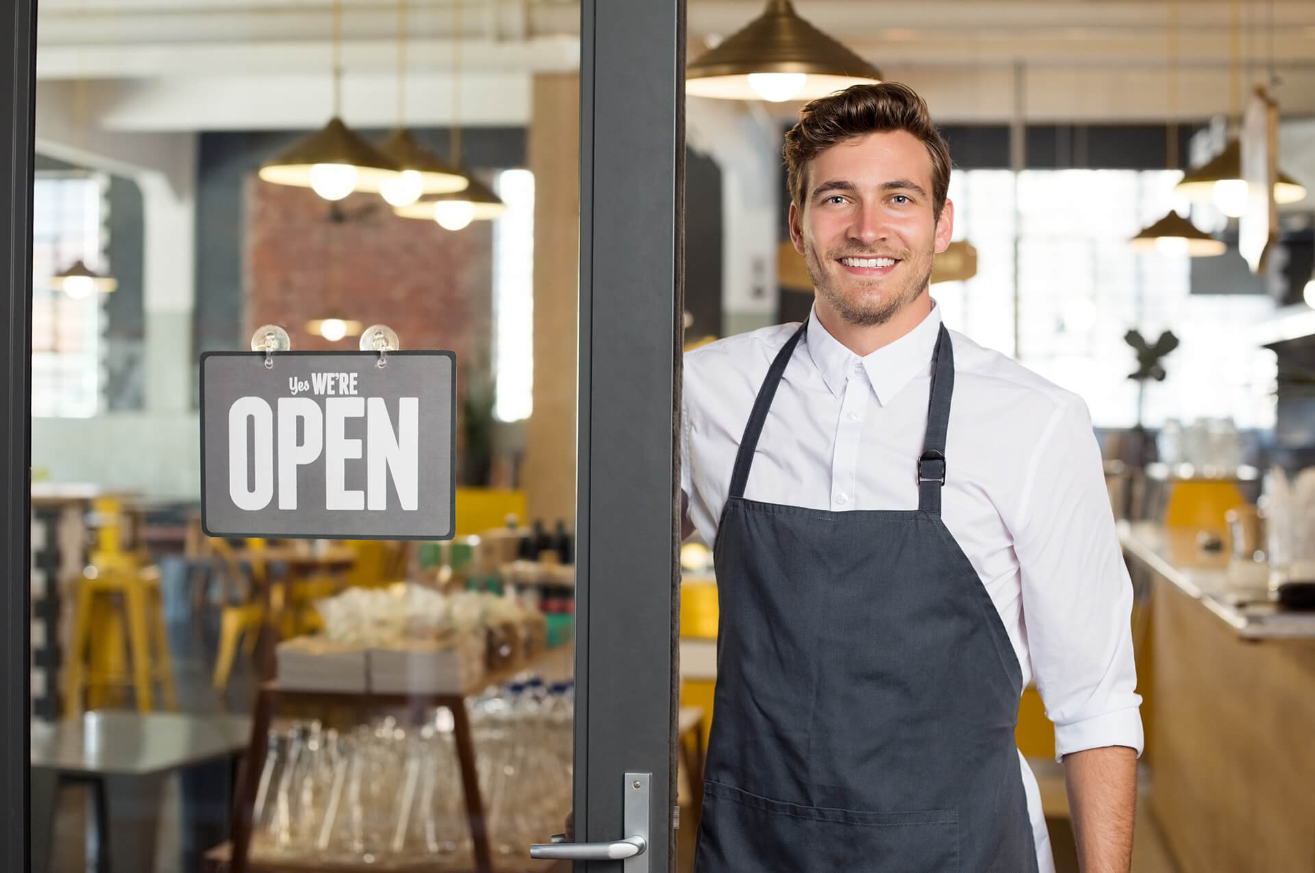 Portrait,Of,Smiling,Owner,Standing,At,His,Restaurant,Gate,With Small Business Consulting
